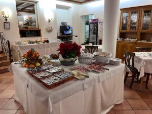 a table with food on it in a restaurant at Hotel Albergo Dolomiti in San Vito di Cadore