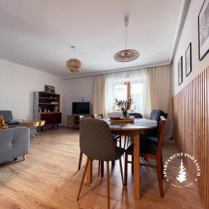 a living room with a table and chairs at APARTAMENT Pod Lasem Jedlina Zdrój in Jedlina-Zdrój