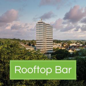 a tall building with the words roof top bar at b-smart hotel Menziken in Menziken