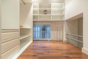 a hallway with white shelves and a staircase with a window at Modern- 2Bd 2Bth - Ópera in Madrid