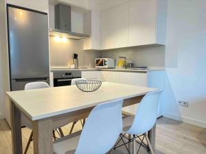 a kitchen with a table and chairs in a kitchen at New Port, Free Parking YBH6A in Vigo