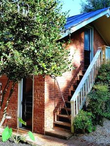 a brick house with a staircase leading to a door at West Park Gardens in Culpeper