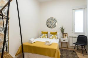 a small bedroom with a bed and a chair at Stylish and Bright - 2Bd 1Bth- Atocha in Madrid
