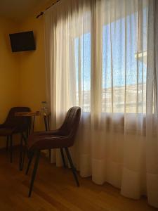 a room with a table and a large window at Hotel Cal Martri in Ger