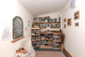 a room with a book shelf filled with books at Beautiful couples retreat with hot tub, central heating and views- The Bee Hive by Get Better Getaways in Glenluce