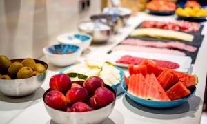 a buffet with bowls of fruit on a table at Zenit Valencia in Valencia