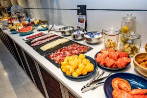 a buffet with many different types of fruits and vegetables at Zenit Valencia in Valencia