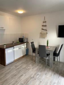 a kitchen with a table and chairs in a kitchen at Family Apartments Lübeck in Lübeck