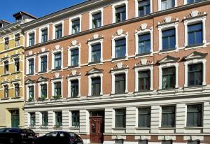 a large brick building with a lot of windows at Flemming in Leipzig