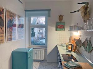 a kitchen with a blue refrigerator and a window at Flemming in Leipzig