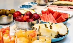 a table topped with bowls of fruit and drinks at Zenit Valencia in Valencia