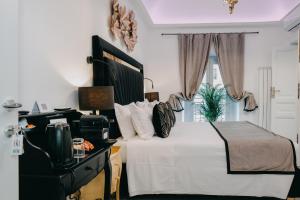 - une chambre avec un lit blanc et une télévision dans l'établissement Imperial Rhome Guest House, à Rome