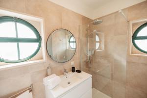 a bathroom with a sink and a mirror at Casa Velha Apartments - Adults friendly in Albufeira