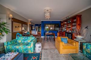 a living room with blue and yellow furniture at The Mandyville Jeffreys Bay in Jeffreys Bay