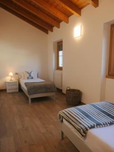 1 Schlafzimmer mit 2 Betten und Holzdecke in der Unterkunft The Lake Home in Colico