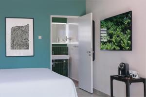 Łóżko lub łóżka w pokoju w obiekcie Kura Botanica Hotel