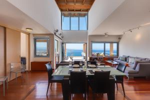 a dining room and living room with a table and chairs at Unlimited Blue in Chania