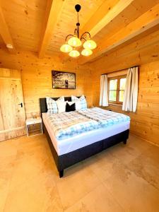 a bedroom with a bed in a wooden room at Ferienhaus Seerose in Übersee
