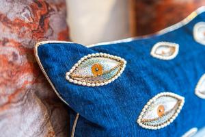 a close up of a blue cushion witheyes at EPIC Duke Street Townhouse, City Centre Apartments in Liverpool +25 photos