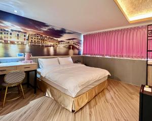 A bed or beds in a room at Good Time Boutique Hotel