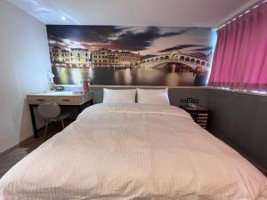 A bed or beds in a room at Good Time Boutique Hotel