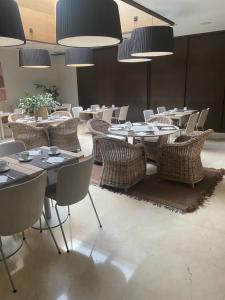 a dining room with tables and chairs and lights at Zenit Valencia in Valencia