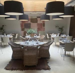 a dining room with tables and chairs and lights at Zenit Valencia in Valencia