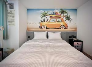 A bed or beds in a room at Good Time Boutique Hotel