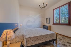 A bed or beds in a room at Il Gabbiano Nuovo a Marina di Campo - Goelba