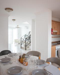 a dining room table with glasses and a pineapple on it at Villa Fariones in Tías