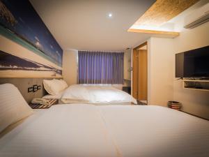 A bed or beds in a room at Good Time Boutique Hotel