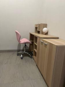 an office with a pink chair and a desk at 2BR JIExpo Menara Jakarta (new) in Jakarta