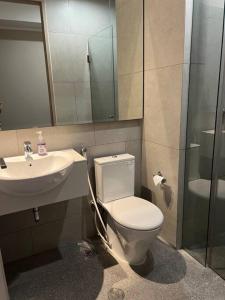 a bathroom with a toilet and a sink and a shower at 2BR JIExpo Menara Jakarta (new) in Jakarta