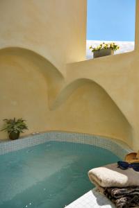 a swimming pool in a building with a pool at Yellow Orchid Cycladic House in Pirgos
