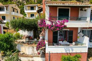 a house with pink flowers on the side of it at Athena's Veranda magestic views in Glyfada beach of Corfu by New Era in Glyfada