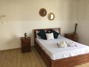 ein Schlafzimmer mit einem Bett mit zwei Hello-Kitty-Kissen in der Unterkunft Sanda GuestHouse in Antsirabe