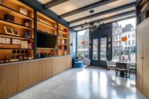 a dining room with a table and a large window at CTY Books in Leiden