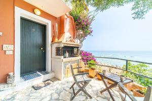 a house with a fireplace and a table and chairs at Athena's Veranda magestic views in Glyfada beach of Corfu by New Era in Glyfada