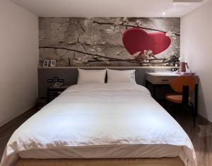 A bed or beds in a room at Good Time Boutique Hotel