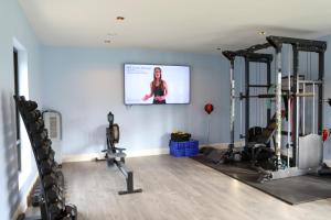a gym with two treadmills and two exercise bikes at 5* Self Catering 1 Bed in Nenagh