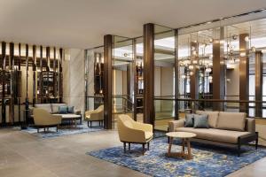 a lobby with couches and chairs and tables at Courtyard by Marriott Tokyo Ginza Hotel in Tokyo