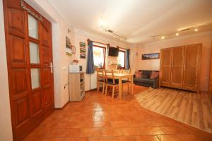 a kitchen and living room with a table and a room at Apartma Felix in Kranjska Gora