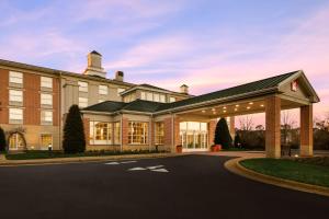 a large building with a parking lot in front of it at Hilton Garden Inn Williamsburg in Williamsburg