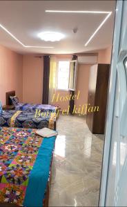 a room with two beds and a glass window at HOSTEL BORDJ EL KIFFAN 2 in Fort de lʼEau