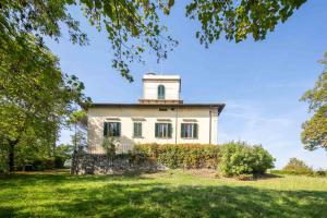 an old house with a tower on top of it at Villa Votanidi by VacaVilla in Borgo San Lorenzo