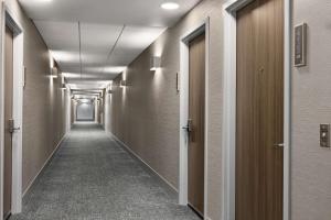 a corridor of a hallway with a long hallway at Homewood Suites by Hilton York in York