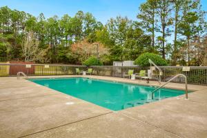 a swimming pool in a yard with a fence at Hampton Inn Mobile-I-10/Bellingrath Gardens in Tillmans Corner