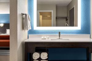 a bathroom with a sink and a mirror at La Quinta by Wyndham Chicago Tinley Park in Tinley Park