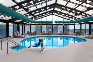 a large swimming pool in a building at La Quinta Inn by Wyndham Wausau in Wausau