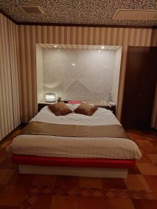 a bedroom with a large bed with a window at Hotel Fantacy (Adult Only) in Hamamatsu